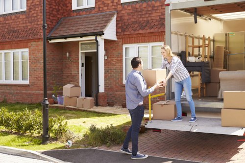 Removal van moving boxes in Battersea on a residential street