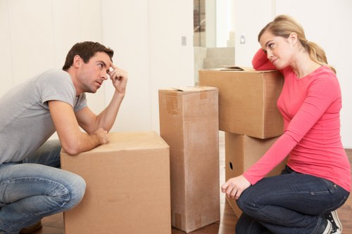 Staff member loading items carefully into a removal van